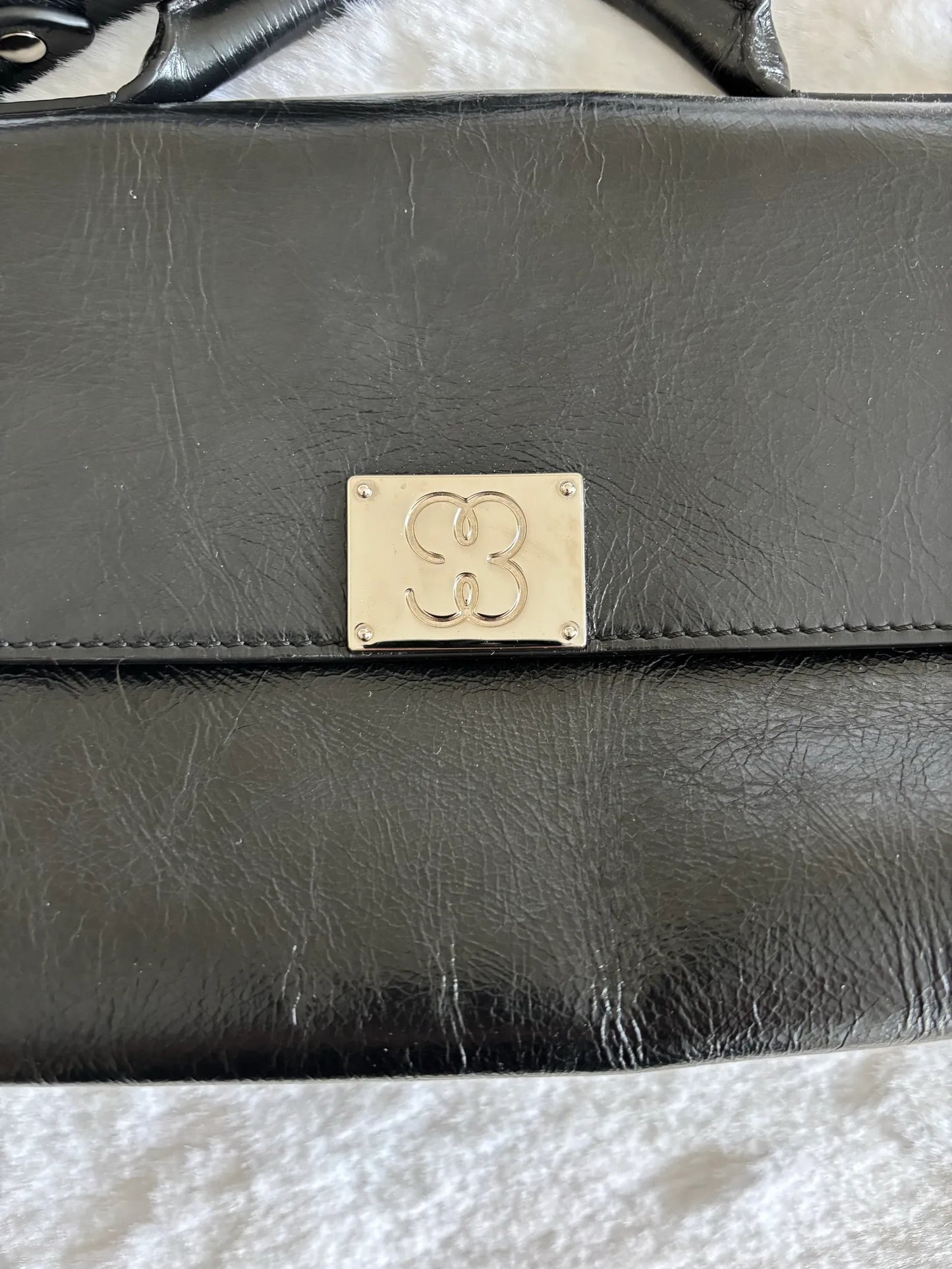 Filippa K 93 Monogram-skinnaxelremsväska
